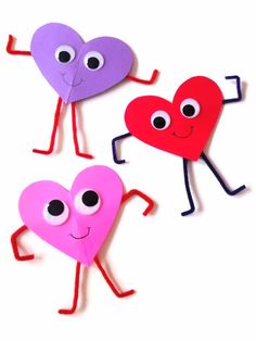 three paper hearts with eyes and arms