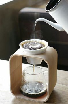 a coffee pot is being filled with water from a pour - o - drip system