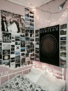 a bedroom with posters and lights on the wall