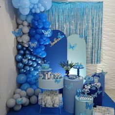 a blue and white dessert table with balloons