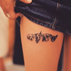 a woman's leg with three dogs on it and the word dog tattoos written in black