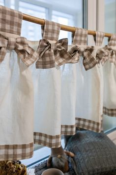 the kitchen is decorated with gingham curtains