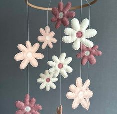 a mobile with flowers hanging from it's sides