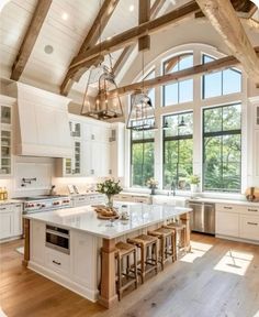 a large kitchen with white cabinets and an island in front of a window that is open to the outside