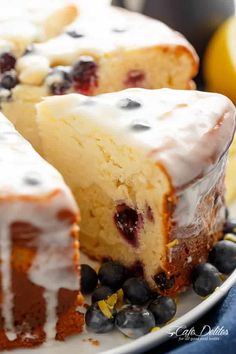 a close up of a cake on a plate with blueberries