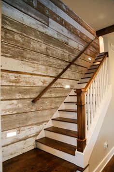 the stairs are made from wood and have white railings