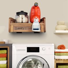 a white washer sitting next to a dryer in a room with shelves on the wall