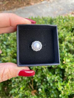 The Pearl is the only gem created in living being. When something penetrates an oyster's shell, it doesn't reject it; it embraces it, encases it & turns it into something beautiful. ♥️ This stunning ring features a freshwater pearl encircled by lustrous crystals. Available in silver or gold. Adjustable, size 5-8 PRODUCT DETAILS: 10mm AAA freshwater button iridescent pearl Luster - High Setting: sterling silver or 14kt gold plated with crystal mount Size: Adjustable, Size 5-8 Materials: Freshwate Wedding Pearl Rings With Pearl Pendant, Elegant Pearl Ring With Pendant As Gift, Round Halo Jewelry For Proposal, Silver Akoya Pearl Drop Ring, Elegant Pearl Ring With Pearl Charm For Gift, Elegant Pearl Ring With Pearl Charm As A Gift, Elegant Pearl Ring With Charm As Gift, Elegant Pearl Pendant Ring As Gift, Silver Akoya Pearl Ring With Pearl Drop