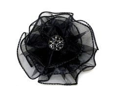 "Hand sewn magnetic black flower brooch attaches to clothing, hats and wraps without leaving a mark! The magnet can also be worn in the hair. The elegant black flower is 4 inches diameter and hand sewn from a wired sheer black ribbon. YOU CHOOSE from 5 choices of unique centerpieces. Pic. 1-Black Rhinestones (.75\") Pic.2- Faceted Oval (1\" L\") Pic.3- Vintage Filagree Button (.75\") Pic.4- Rhinestone Flower ) (1\") Ships gift wrapped in an organza bag To see my entire line of MAGNETIC BROOCHES Magnetic Brooch, Scarf Pins, Fancy Ribbon, Fabric Flower Brooch, Brooch Diy, Unique Centerpieces, Scarf Pin, Cocktail Hat, Annual Meeting