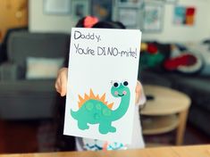 a child holding up a card that says daddy, you're dim - lite