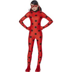 a woman wearing a red and black polka dot costume with her hands on her hips