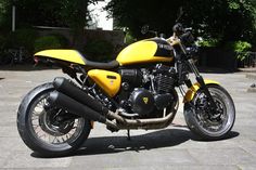 a yellow and black motorcycle parked on the street