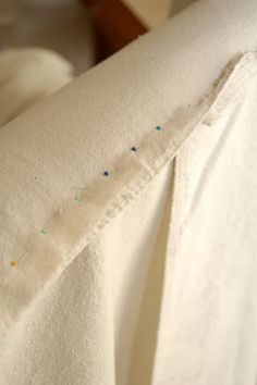 the back of a white shirt with blue and green sprinkles on it