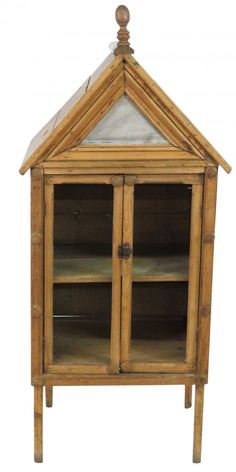 a wooden cabinet with glass doors and shelves on the top, in front of a white background