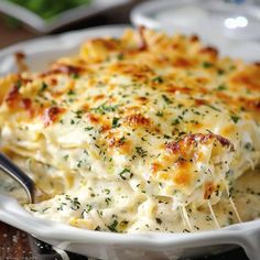 a close up of a casserole dish on a plate with a fork in it