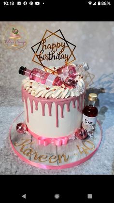 a birthday cake with pink icing and decorations