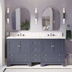 a bathroom with two sinks and mirrors on the wall