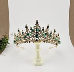 Introducing Simone our custom Gold Green Quinceanera Tiara - perfect for your special event! Whether it's your big day as a bride, a Quinceanera, or a pageant, this Emerald Green bridal tiara will be the crowning glory of your outfit. Crafted with exquisite attention to detail and green and clear stones, green beads it's sure to add a hint of royalty to your look. Add a custom name plate to your tiara! Just leave the name spelled correctly in the box. It's $40 extra and will take 1 to 2 weeks in Green Quinceanera, Tiara Necklace, Quinceanera Tiaras, Quinceanera Crown, Crystal Bridal Tiaras, Gold Tiara, Green Beads, Wedding Tiara, Wedding Headpiece