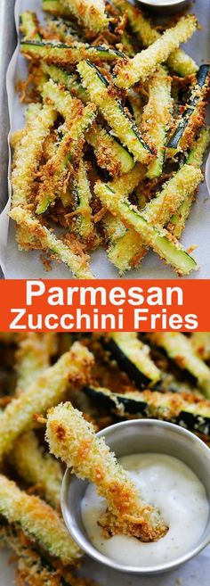 some fried zucchini fries are on a tray with dipping sauce in the middle