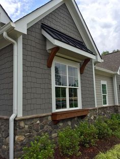 a gray house with white trim and windows