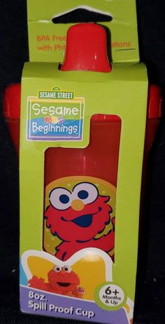 the sesame street sesame beginnings sippy cup is in its box and it's red