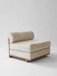 a white couch sitting on top of a wooden frame