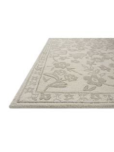 an area rug with flowers and leaves on the bottom, in light grey tones is shown