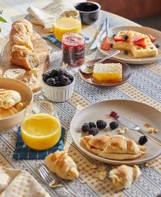 a table topped with plates and bowls filled with food