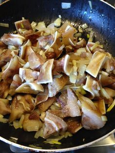 some food is cooking in a skillet on the stove top and ready to be cooked