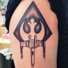 a star wars tattoo on the back of a woman's arm