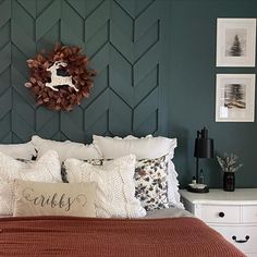 a bedroom with a bed, dresser and wreath on the wall