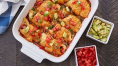 a casserole dish filled with tofu, tomatoes and cucumbers