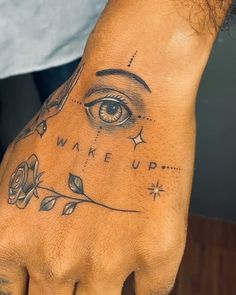 a person with a tattoo on their hand and an eye drawn on the other hand