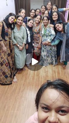 a group of women standing next to each other on top of a hard wood floor