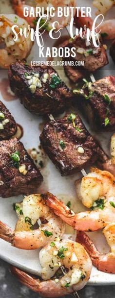 garlic butter steak and shrimp kabobs on a white plate with text overlay