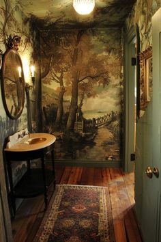 a bathroom with a painting on the wall next to a sink and mirror in it