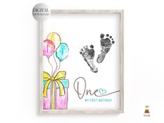 a baby's hand and foot print in a wooden frame with the words, one my first birthday