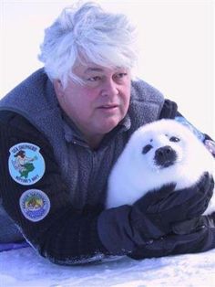 a man holding a panda bear in his hands with the caption a true hero