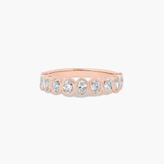 a rose gold ring with five diamonds