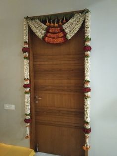 the door is decorated with flowers and garlands