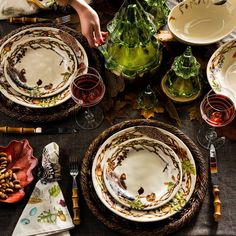 the table is set with dishes and place settings