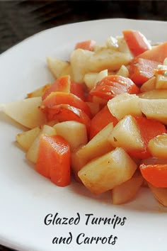 a white plate topped with sliced carrots and pasta salad on top of a wooden table