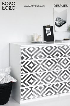 a black and white patterned dresser next to a chair