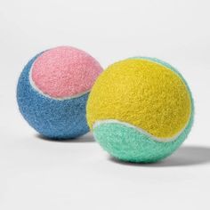 two tennis balls with different colors and sizes on a white background, side by side