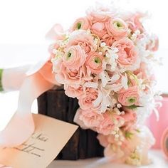 a bouquet of pink flowers sitting on top of a table