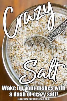 a glass jar filled with salt on top of a wooden table