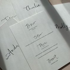 four wedding programs with calligraphy on them