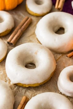 there are many donuts with cinnamon sticks on the table