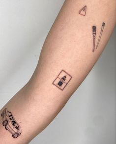 a person's arm with some tattoos on it