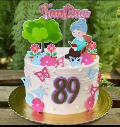 a birthday cake with an old lady sitting on the top and flowers in the middle